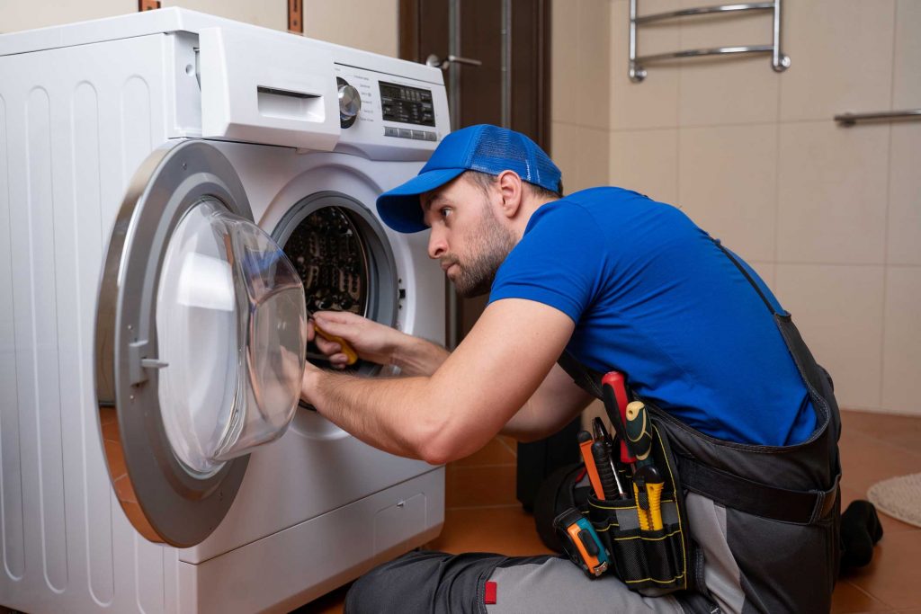 a technician repairing a washer and dryer repair Staten Island